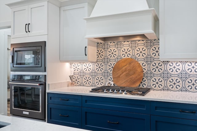 22 Flip Flop Ct, Winchester, TN 37398 - kitchen featuring blue cabinets, custom exhaust hood, built in microwave, and wall oven