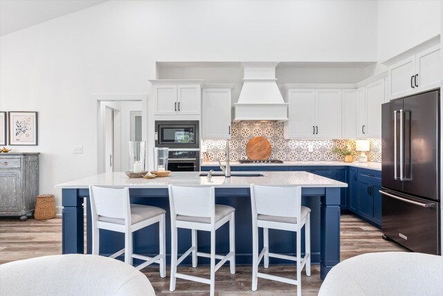 22 Flip Flop Ct, Winchester, TN 37398 - kitchen with light countertops, custom exhaust hood, light wood-style floors, and appliances with stainless steel finishes