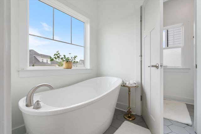 22 Flip Flop Ct, Winchester, TN 37398 - full bath featuring a freestanding bath, tile patterned floors, and baseboards