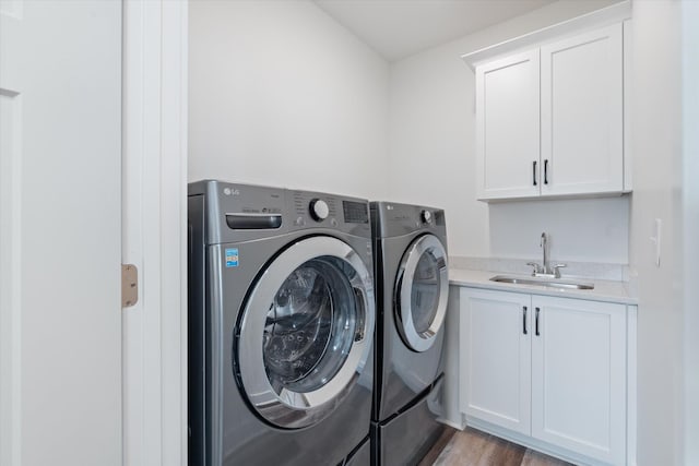 22 Flip Flop Ct, Winchester, TN 37398 - laundry room featuring a sink, bar area, cabinet space, light wood finished floors, and independent washer and dryer