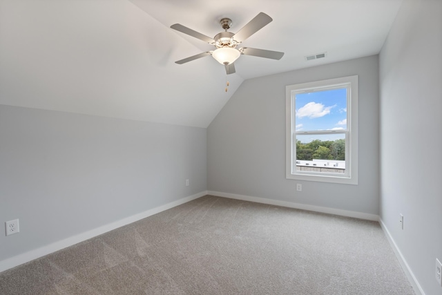 bonus room featuring visible vents, light colored carpet, vaulted ceiling, and a ceiling fan