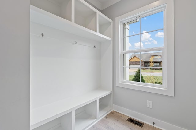 mudroom with visible vents, baseboards, and light wood-style flooring