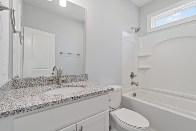 full bath featuring toilet, vanity, and shower / washtub combination