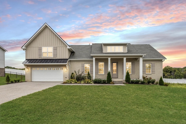 view of front of property with a yard, covered porch, fence, an attached garage, and driveway