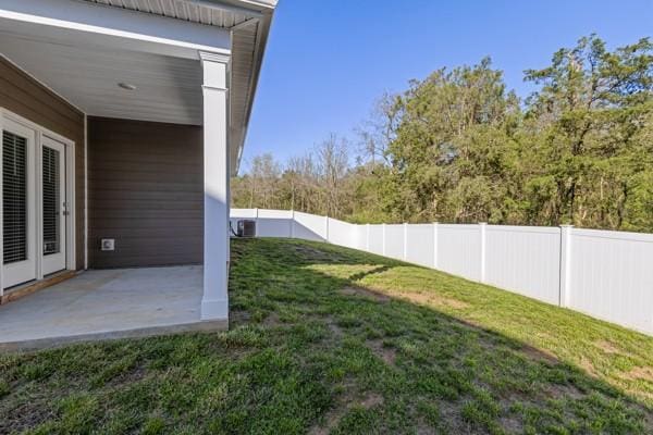 view of yard with a fenced backyard and a patio