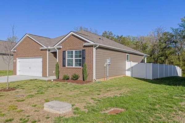 view of property exterior featuring driveway, an attached garage, brick siding, fence, and a lawn