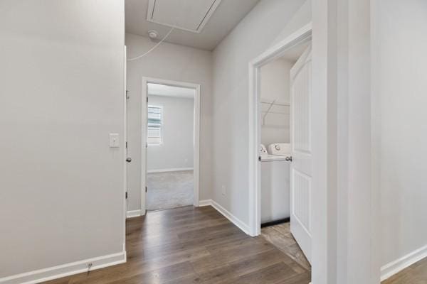 corridor featuring separate washer and dryer, baseboards, attic access, and wood finished floors