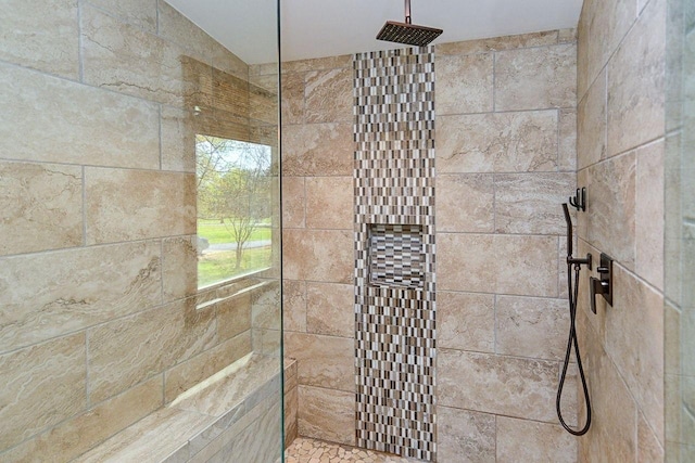 interior details with a tile shower