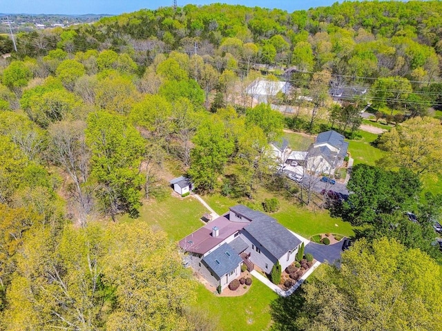 bird's eye view featuring a wooded view