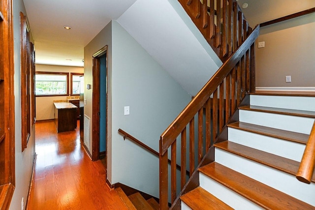 stairway featuring recessed lighting, visible vents, and wood finished floors