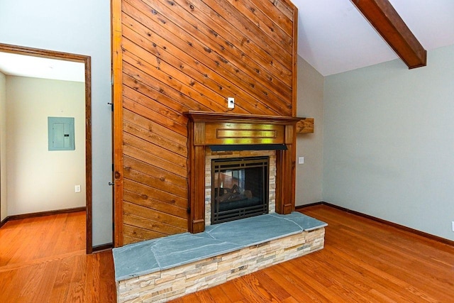 unfurnished living room with electric panel, baseboards, a multi sided fireplace, and wood finished floors