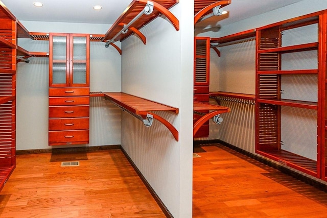 spacious closet featuring visible vents and wood finished floors