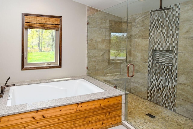 full bath with a bath and a stall shower