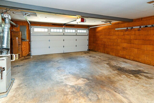 garage featuring electric panel and a garage door opener