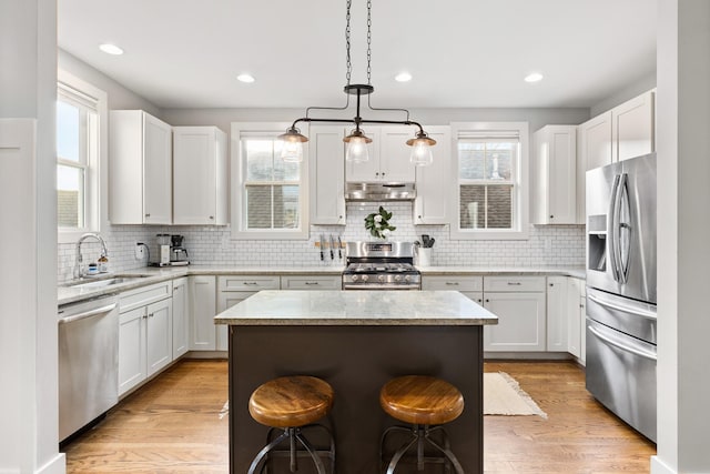 4008 Nevada Ave, Nashville, TN 37209 - kitchen with a sink, light wood-style floors, under cabinet range hood, white cabinetry, and stainless steel appliances