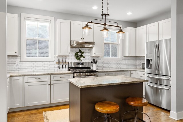 4008 Nevada Ave, Nashville, TN 37209 - kitchen with a center island, appliances with stainless steel finishes, light wood-style floors, and under cabinet range hood