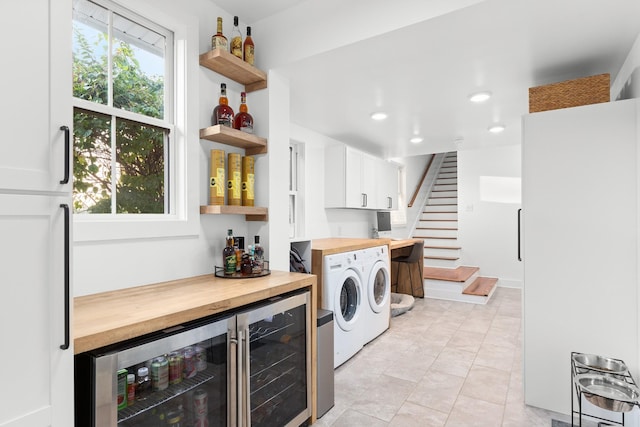 4008 Nevada Ave, Nashville, TN 37209 - laundry room with recessed lighting, light tile patterned floors, washing machine and dryer, a dry bar, and wine cooler