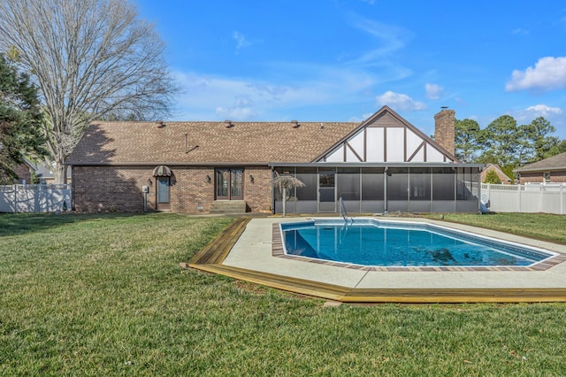 view of pool with a sunroom, a fenced backyard, a fenced in pool, and a lawn