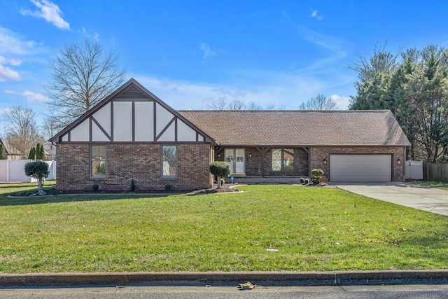 tudor house featuring a front yard, fence, brick siding, an attached garage, and concrete driveway