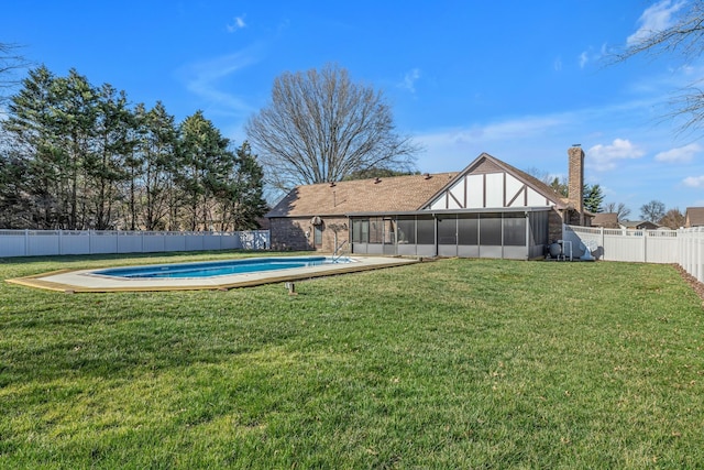 view of yard featuring a sunroom, a fenced backyard, and a fenced in pool