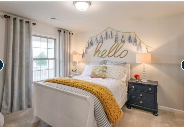 bedroom featuring light carpet, baseboards, and visible vents