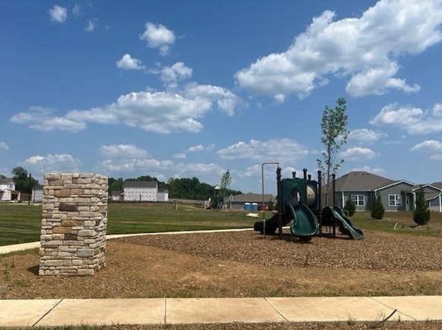 communal playground featuring a yard
