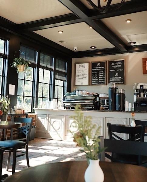 bar featuring coffered ceiling, beamed ceiling, and recessed lighting