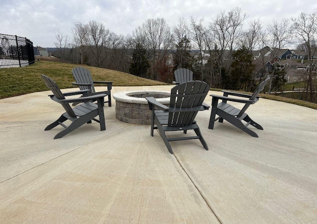 view of patio / terrace featuring fence and a fire pit