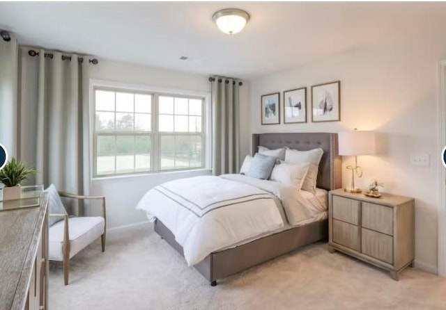 bedroom with light carpet and baseboards