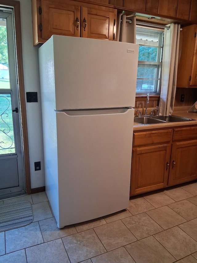 615 Lemont And Yates Mountain Rd, Spencer, TN 38585 - kitchen with freestanding refrigerator, brown cabinets, plenty of natural light, and light countertops