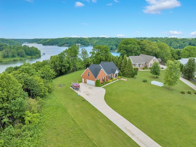 bird's eye view with a water view and a forest view