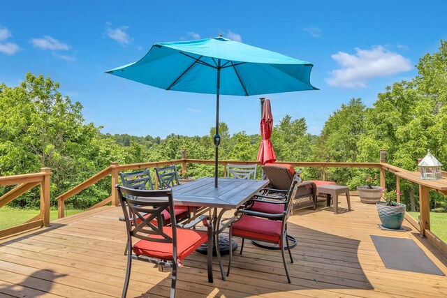 wooden terrace with outdoor dining area