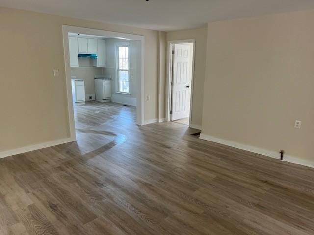 spare room with wood finished floors and baseboards