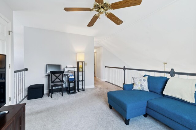 carpeted living area with ceiling fan, baseboards, and lofted ceiling