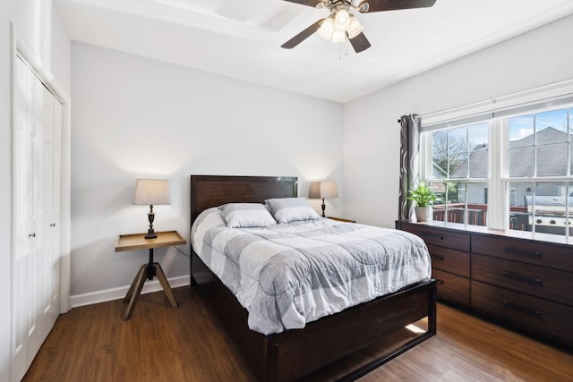 bedroom with baseboards, a closet, a ceiling fan, and wood finished floors