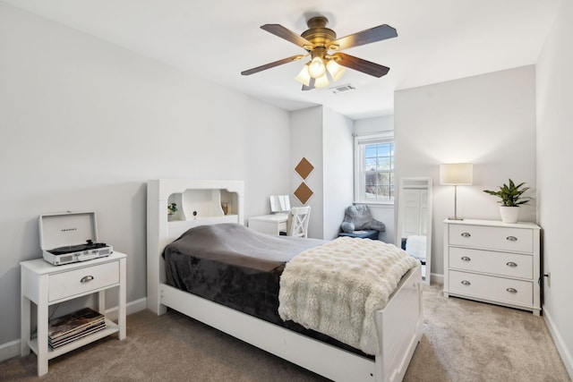 bedroom with visible vents, baseboards, ceiling fan, and light carpet
