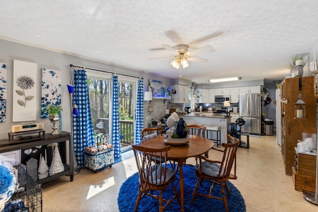 dining space with a textured ceiling and ceiling fan