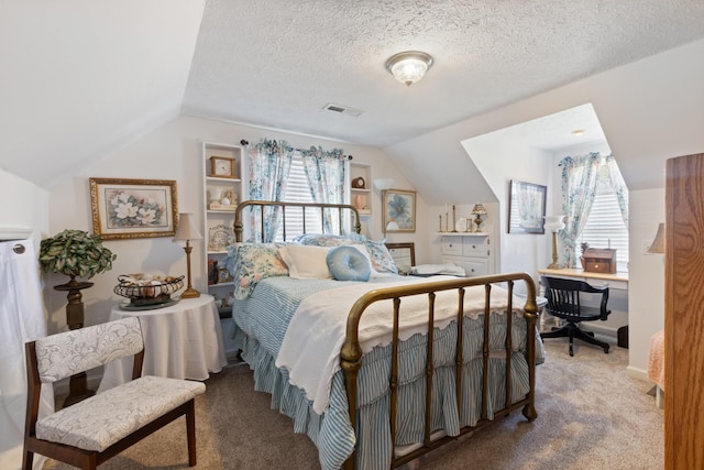 bedroom featuring visible vents, carpet flooring, and vaulted ceiling