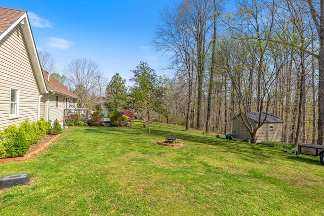 view of yard with an outdoor fire pit and a wooden deck