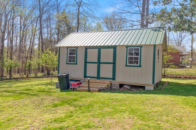 view of outbuilding with a fenced backyard and an outbuilding