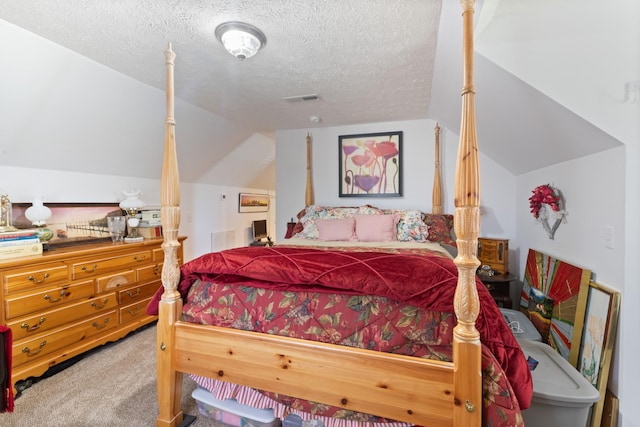 carpeted bedroom with a textured ceiling, visible vents, and vaulted ceiling