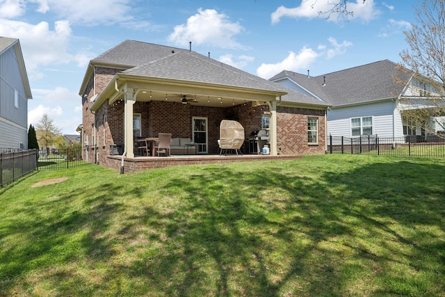 7025 Headwaters Dr, Franklin, TN 37064 - rear view of property featuring brick siding, a fenced backyard, a ceiling fan, and a lawn