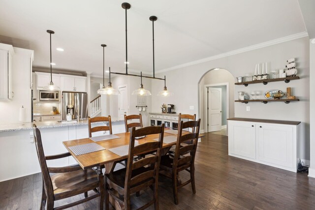 7025 Headwaters Dr, Franklin, TN 37064 - dining space with recessed lighting, arched walkways, ornamental molding, and dark wood finished floors