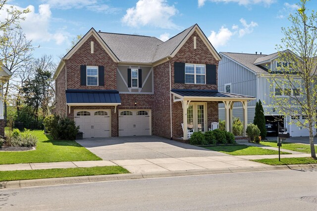 7025 Headwaters Dr, Franklin, TN 37064 - view of front of house with a standing seam roof, brick siding, an attached garage, and concrete driveway