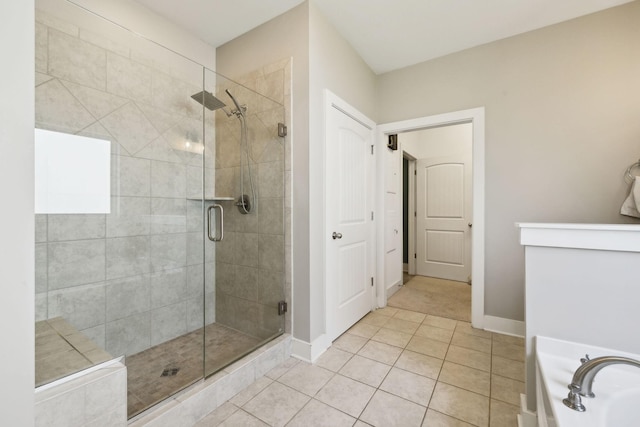7025 Headwaters Dr, Franklin, TN 37064 - full bath with a stall shower, a bathing tub, baseboards, and tile patterned floors