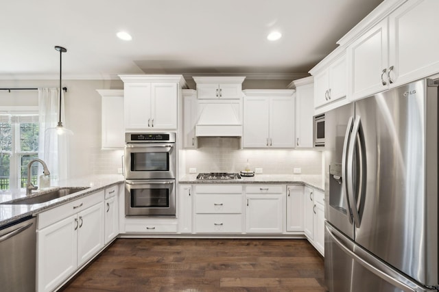 7025 Headwaters Dr, Franklin, TN 37064 - kitchen featuring crown molding, premium range hood, a sink, and stainless steel appliances