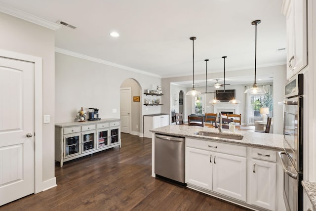 7025 Headwaters Dr, Franklin, TN 37064 - kitchen with arched walkways, crown molding, a sink, and stainless steel appliances