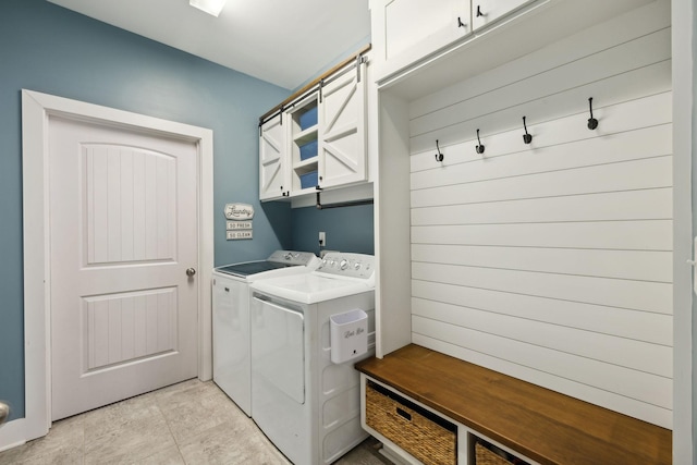 7025 Headwaters Dr, Franklin, TN 37064 - laundry area with light tile patterned floors, washer and clothes dryer, and cabinet space