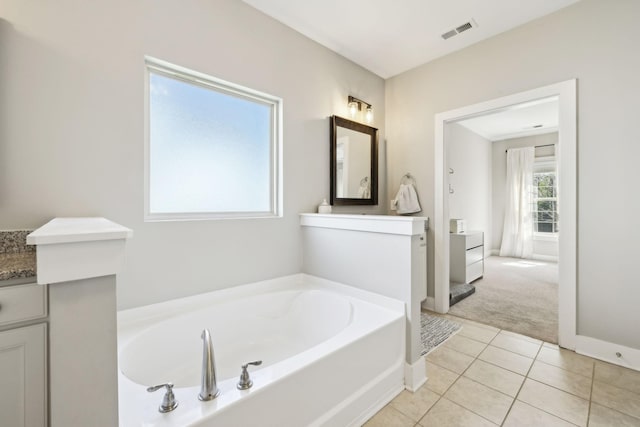 7025 Headwaters Dr, Franklin, TN 37064 - bathroom featuring a garden tub, vanity, visible vents, tile patterned floors, and baseboards