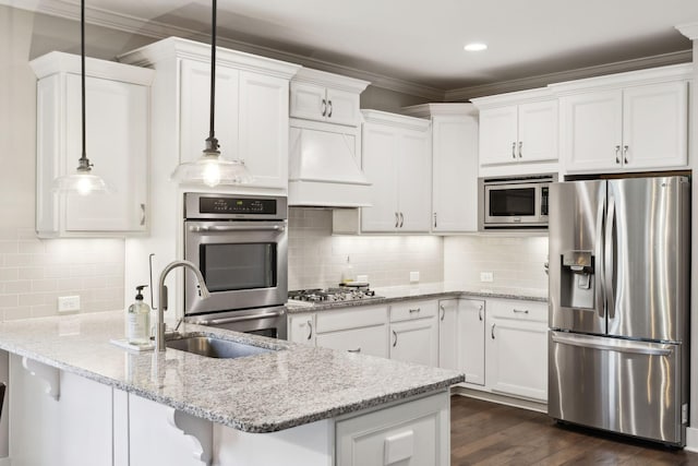 7025 Headwaters Dr, Franklin, TN 37064 - kitchen with a peninsula, white cabinetry, appliances with stainless steel finishes, a sink, and custom range hood